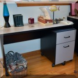 F102. Laminate desk and rolling drawers. 